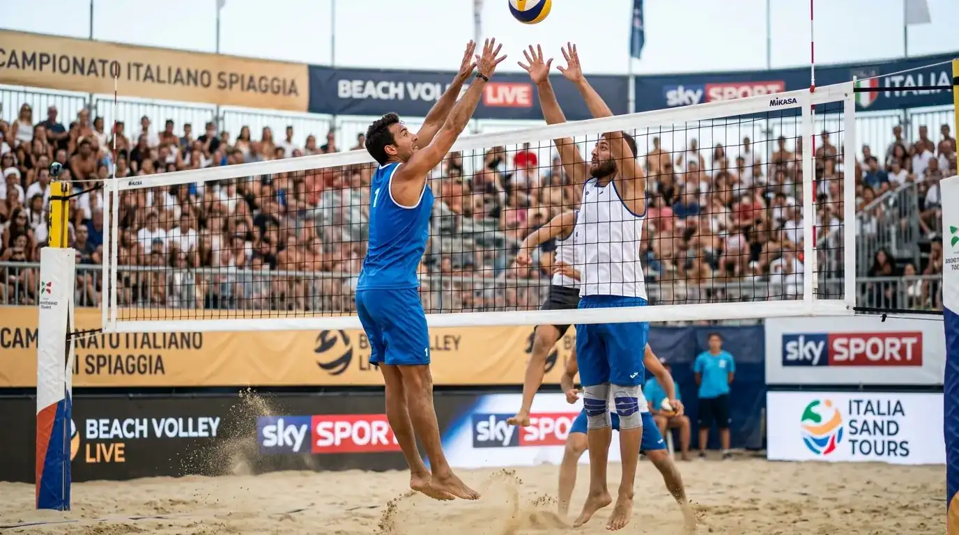 Coppia maschile di beach volley con divise nazionali in difesa di rete